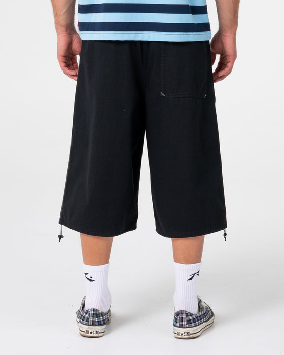 man-wearing-mamba-3-4-baggy-short-in-black