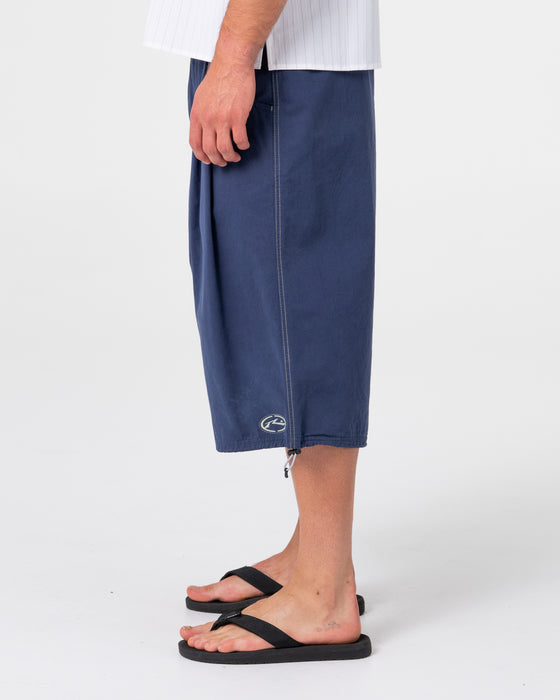 man-wearing-mamba-3-4-baggy-short-in-dark-blue