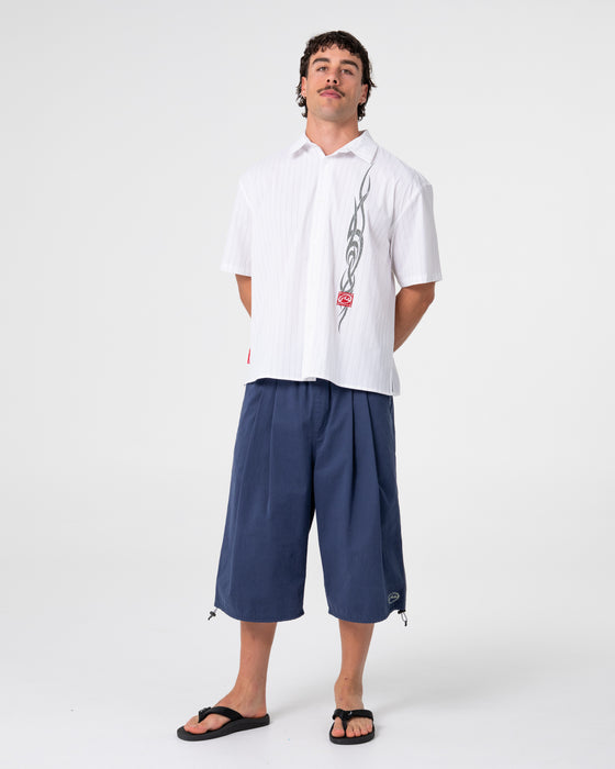 man-wearing-mamba-3-4-baggy-short-in-dark-blue