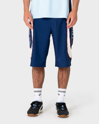 Model wearing Drop In Fixed Waist Boardshort in Navy Blue