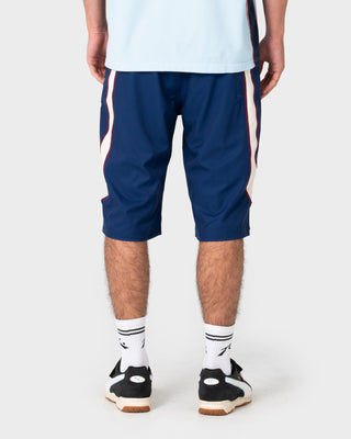 Model wearing Drop In Fixed Waist Boardshort in Navy Blue