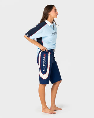 Model wearing Drop In Fixed Waist Boardshort in Navy Blue