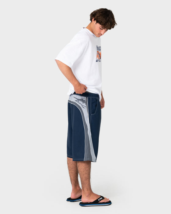 man-wearing-rusty-x-halco-24-elastic-waist-boardshort-in-navy-blue