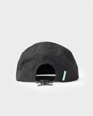 Model wearing HAL X Rusty Nylon 5 Panel Cap in Black