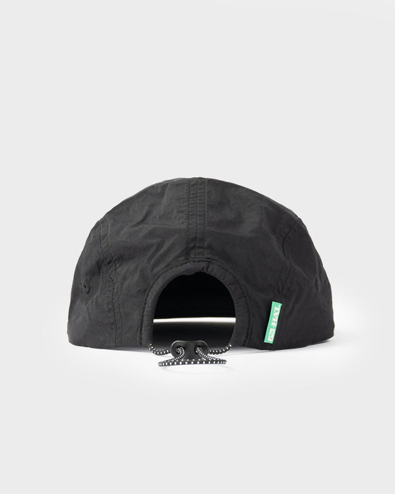model-wearing-hal-x-rusty-nylon-5-panel-cap-in-black