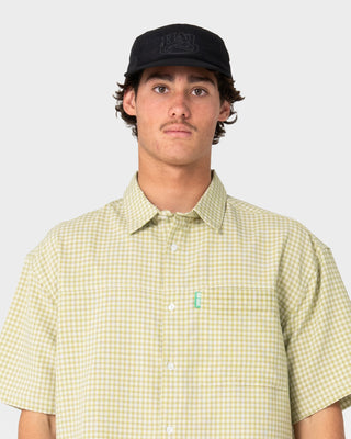 Model wearing HAL X Rusty Nylon 5 Panel Cap in Black