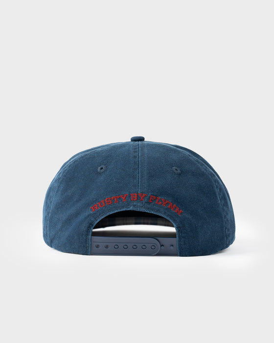 model-wearing-rusty-x-five-by-flynn-cap-in-navy-blue