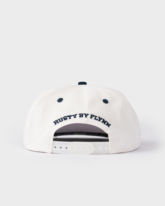 model-wearing-rusty-x-five-by-flynn-cap-in-plaid