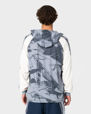 Man wearing Rusty x Halco Long Sleeve Hooded Tee in Stone Grey