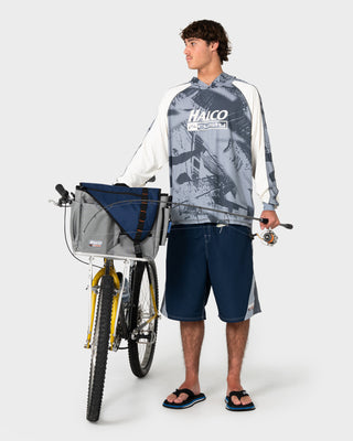 Man wearing Rusty x Halco Long Sleeve Hooded Tee in Stone Grey