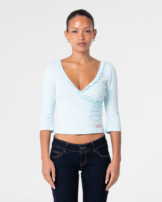 Woman wearing Naomi Deep Vee 3/4 Sleeve Top in Pale Mint