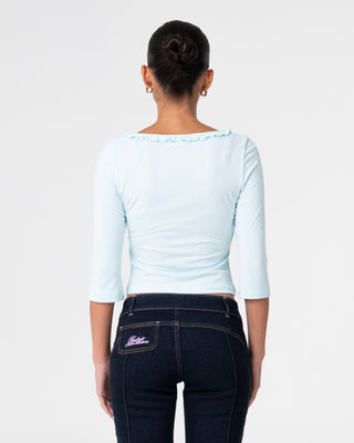 Woman wearing Naomi Deep Vee 3/4 Sleeve Top in Pale Mint