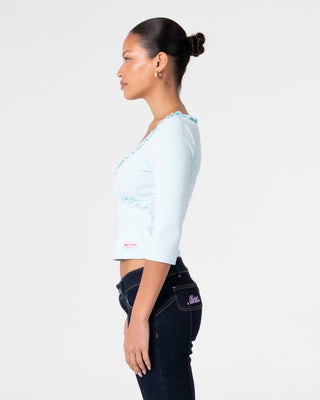 Woman wearing Naomi Deep Vee 3/4 Sleeve Top in Pale Mint