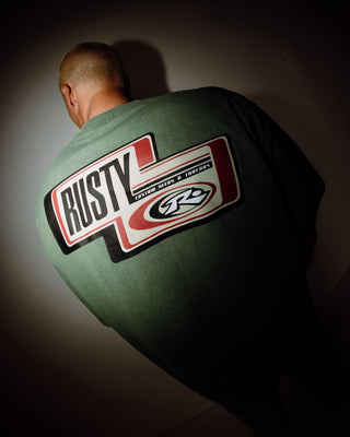 Man wearing Sleds N Threads Short Sleeve Tee in Oil Green