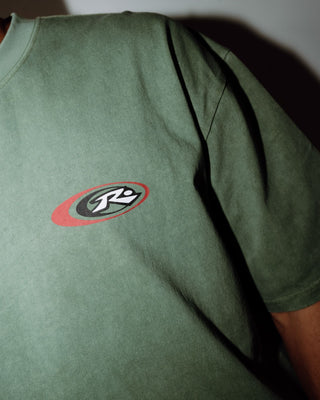 Man wearing Sleds N Threads Short Sleeve Tee in Oil Green