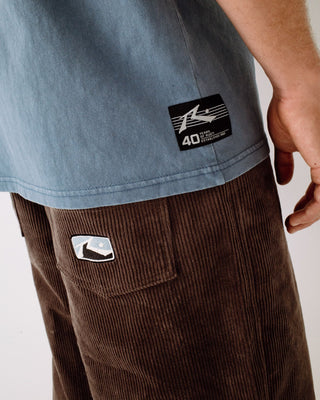 Man wearing Sleds N Threads Short Sleeve Tee in Real Teal