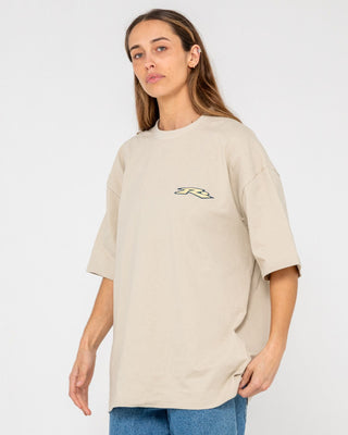 Man wearing Surfing Co Short Sleeve Tee in Stone