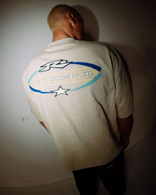 Man wearing Surfing Co Short Sleeve Tee in Stone