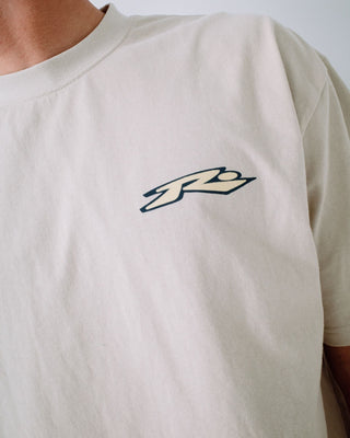 Man wearing Surfing Co Short Sleeve Tee in Stone
