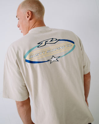 Man wearing Surfing Co Short Sleeve Tee in Stone