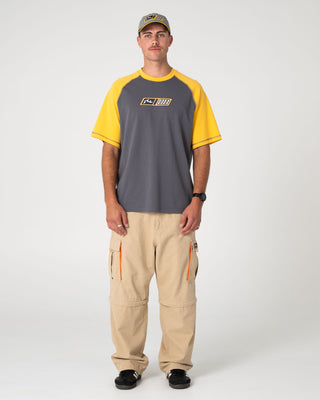 Man wearing Waka Raglan Short Sleeve Tee in Steel