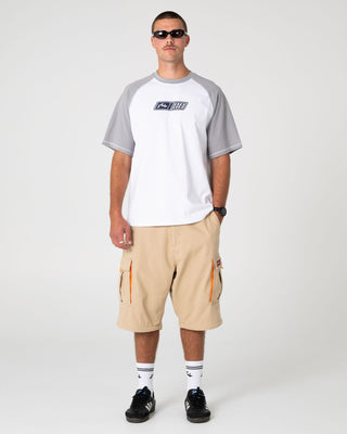 Man wearing Waka Raglan Short Sleeve Tee in White