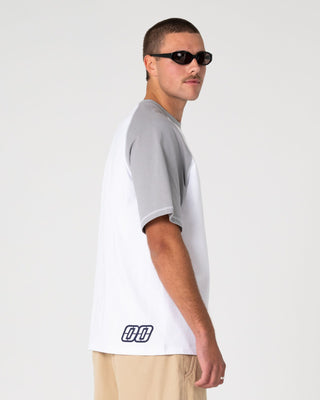 Man wearing Waka Raglan Short Sleeve Tee in White