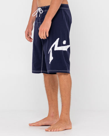 Man wearing Fixed Competition Revolution Boardshort in Navy Blue