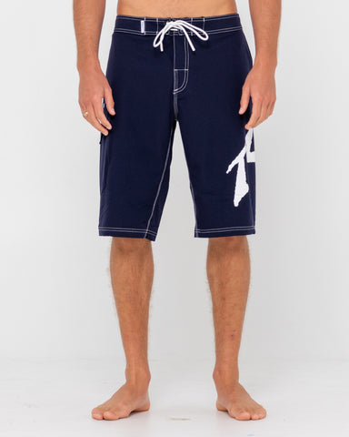 Man wearing Fixed Competition Revolution Boardshort in Navy Blue