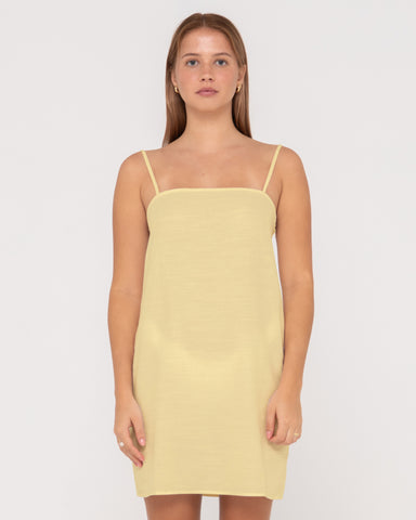 Woman wearing Sweet Water Mini Dress in Lemon Yellow