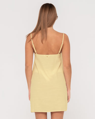 Woman wearing Sweet Water Mini Dress in Lemon Yellow