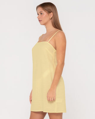 Woman wearing Sweet Water Mini Dress in Lemon Yellow