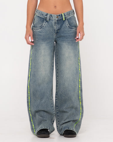 Woman wearing Flip Mommy Low Rise Wide Leg Denim Jean in Dirty Dawg / Lime