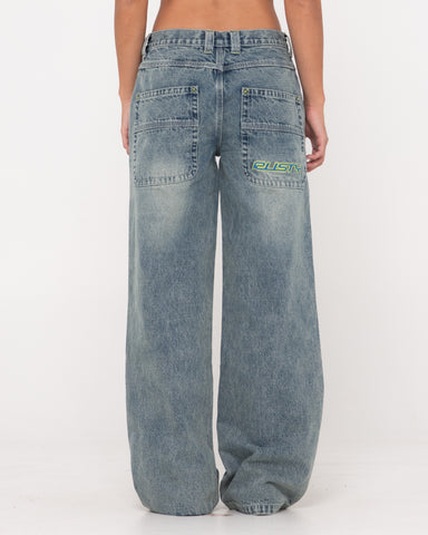 Woman wearing Flip Mommy Low Rise Wide Leg Denim Jean in Dirty Dawg / Lime