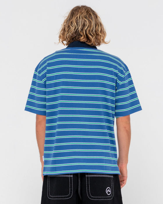 man-wearing-inspectah-deck-short-sleeve-polo-in-delft-blue