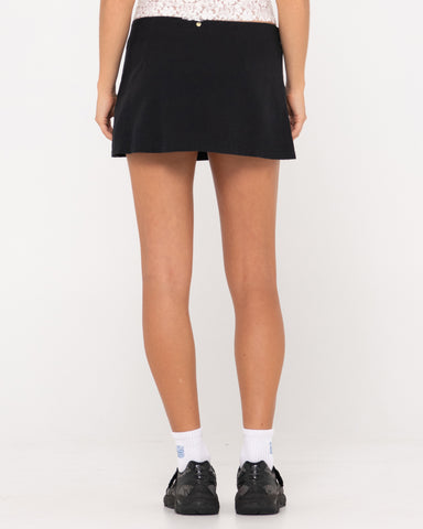 Woman wearing Percy Plaid Low Rise Mini Skirt in Black