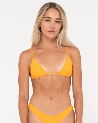 Woman wearing Sandalwood Slick Triangle Bikini Top in Bright Tangerine