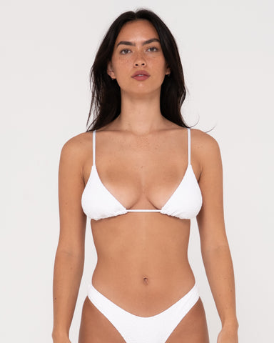 Woman wearing Sandalwood Slick Triangle Bikini Top in Bright White