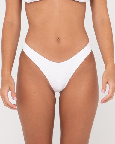 Woman wearing Sandalwood Brazilian Bikini Pant in Bright White