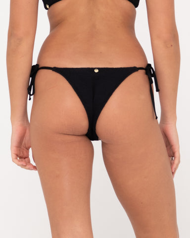 Woman wearing Sandalwood Midi Side Ties Bikini Pant in Black