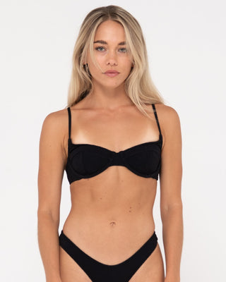 Woman wearing Sandalwood Balconette Bikini Top in Black