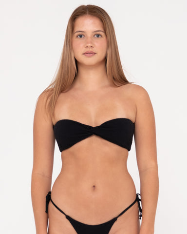 Woman wearing Sandalwood Twist Bandeau Bikini Top in Black