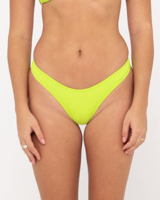 Woman wearing Lime A Dozen Brazilian Pant in Lime Punch