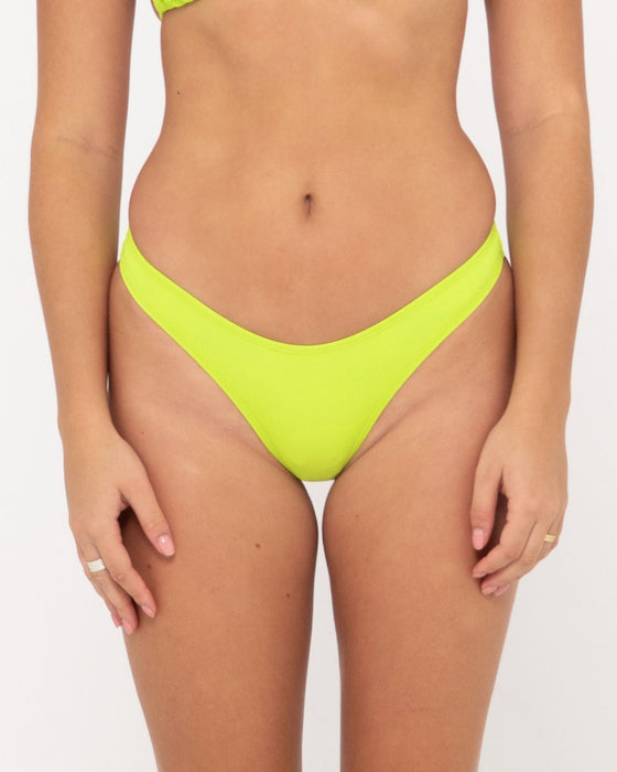 woman-wearing-lime-a-dozen-brazilian-pant-in-lime-punch