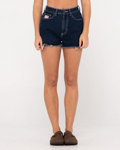 Woman wearing Penny Kick Flare Denim Short in Deep Blue