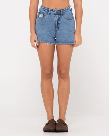 Woman wearing Penny Kick Flare Denim Short in Middy Blue