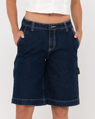 Woman wearing Billie Low Rise Carpenter Jort in Deep Blue