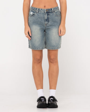 Woman wearing High Volume 18 Inch Denim Jort in Dirty Dawg