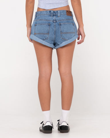 Woman wearing Pheonix Low Rise Denim Mini Short in Middy Blue