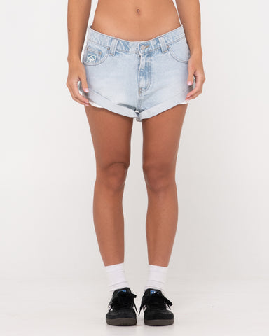 Woman wearing Pheonix Low Rise Denim Mini Short in Sky Blue Heather